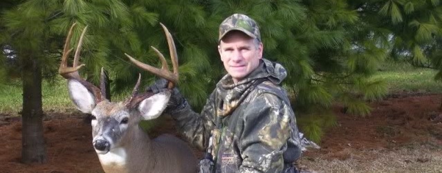 author posing with whitetail buck